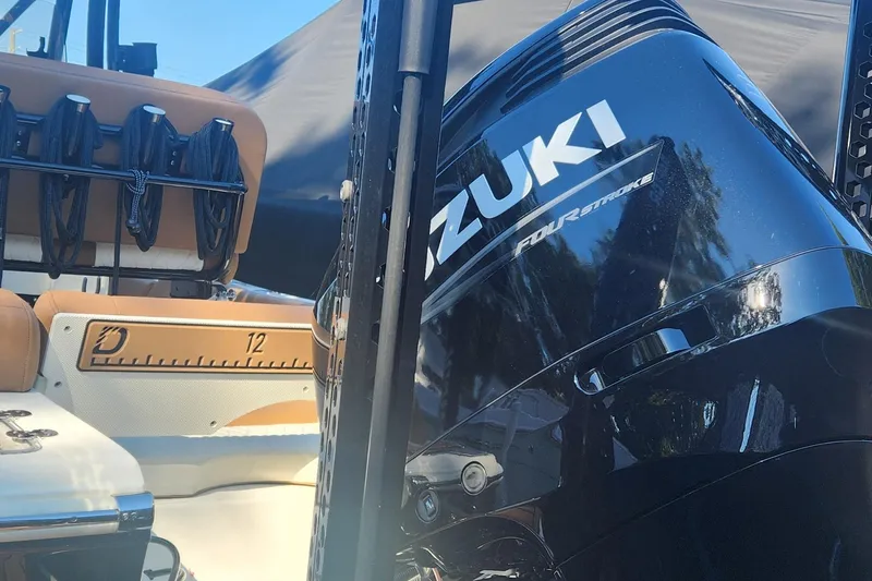 Slide: The Image of 2022 Pioneer 222 Islander boat with Suzuki four-stroke engine, featuring tan seating and rod holders. - 6
