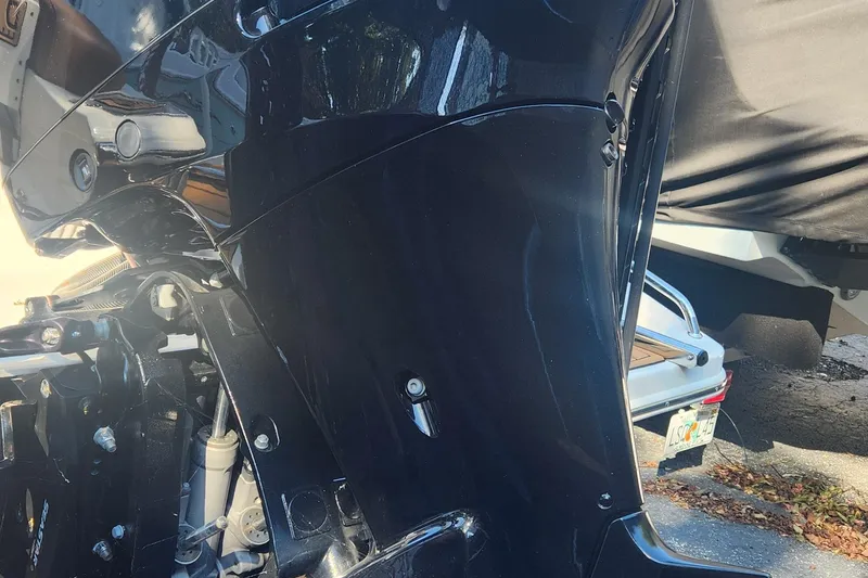 Slide: The Image of 2022 Pioneer 222 Islander boat engine close-up, showcasing sleek black design. - 8