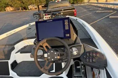 Slide: The Image of 2026 Skeeter ZXE20 boat dashboard with steering wheel and electronic display. - 7