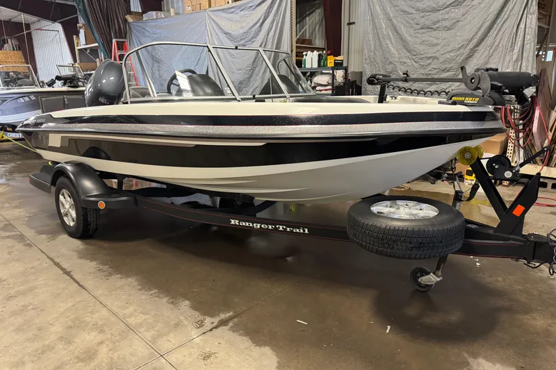 Slide: The Image of 2008 Ranger 1850 Reata boat on trailer in a garage setting. - 1