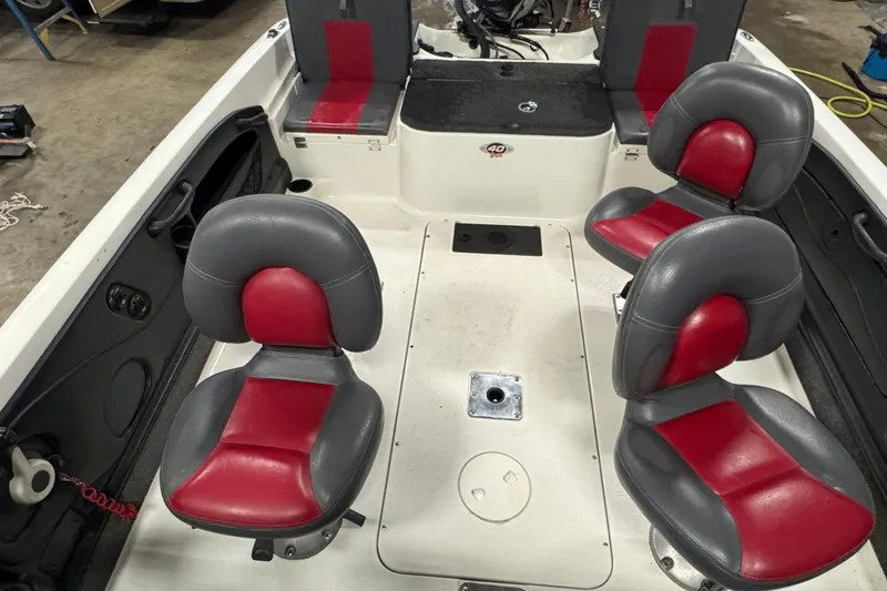 Slide: The Image of 2008 Ranger 1850 Reata boat interior with red and gray seating arrangement. - 10