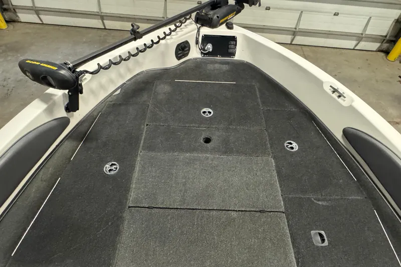 Slide: The Image of 2008 Ranger 1850 Reata boat deck with trolling motor in a garage setting. - 12