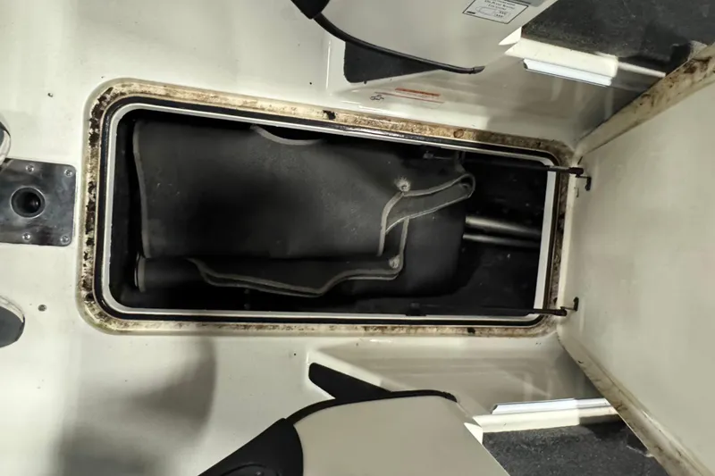 Slide: The Image of Storage compartment in a 2008 Ranger 1850 Reata boat, showing interior details. - 16