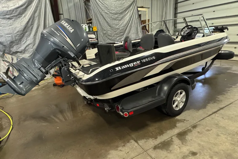 Slide: The Image of 2008 Ranger 1850 Reata boat with Yamaha outboard motor in a garage setting. - 2