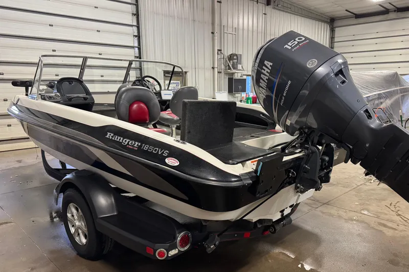 Slide: The Image of 2008 Ranger 1850 Reata boat with Yamaha 150 outboard motor in a garage. - 3