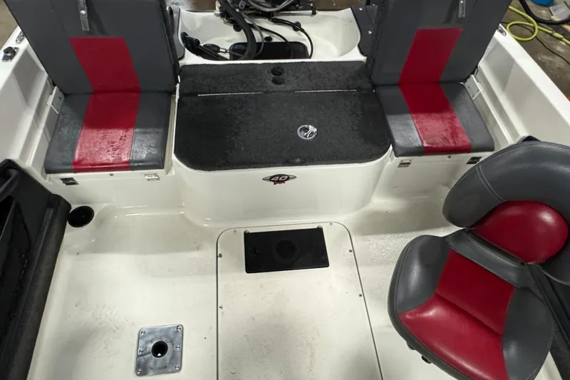 Slide: The Image of Interior of a 2008 Ranger 1850 Reata boat with red and gray seating. - 4