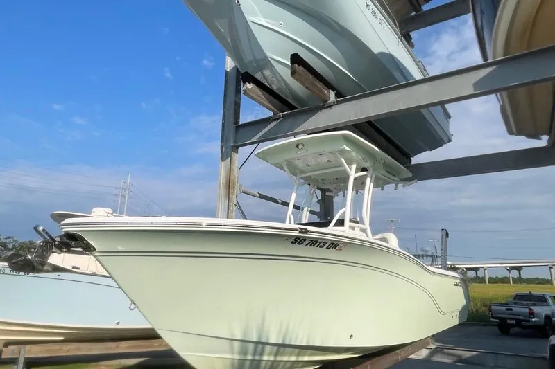 The Image of 2020 Sea Fox 248 Commander boat stored on a rack under a clear blue sky. - 0