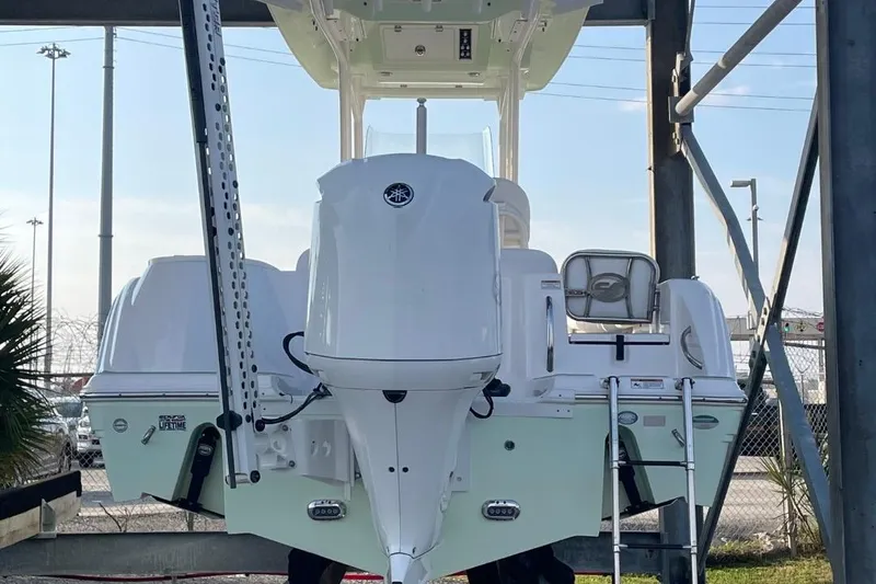 Slide: The Image of 2020 Sea Fox 248 Commander boat, rear view, showcasing engine and ladder. - 2