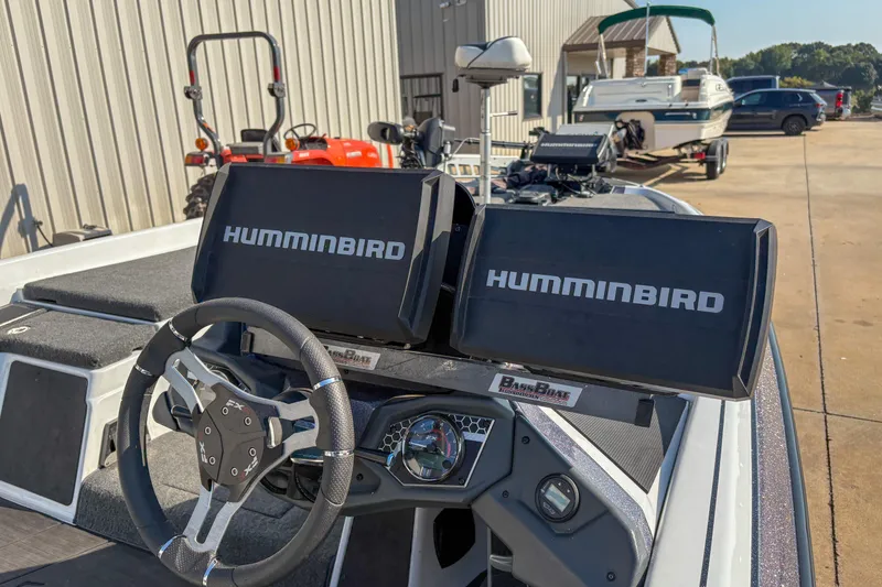 Slide: The Image of 2022 Skeeter FXR20 boat dashboard with dual Humminbird displays and steering wheel. - 14