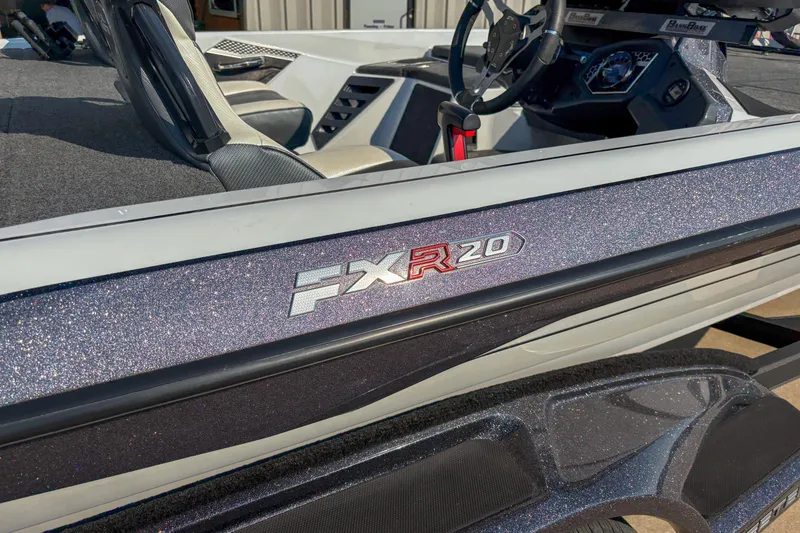 Slide: The Image of 2022 Skeeter FXR20 boat interior with steering wheel and seating details. - 2