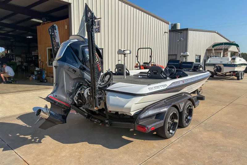 Slide: The Image of 2022 Skeeter FXR20 boat on trailer outside a service facility. - 3