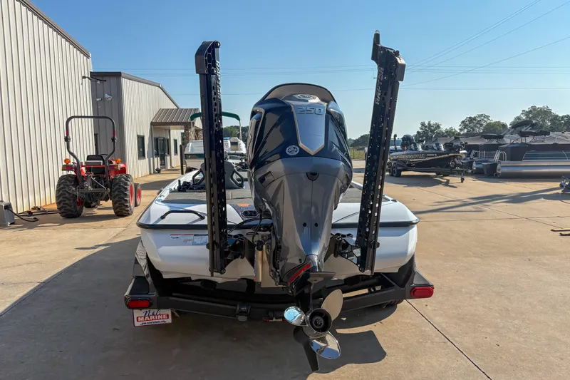 Slide: The Image of 2022 Skeeter FXR20 boat with powerful outboard motor, parked outdoors near a building. - 4