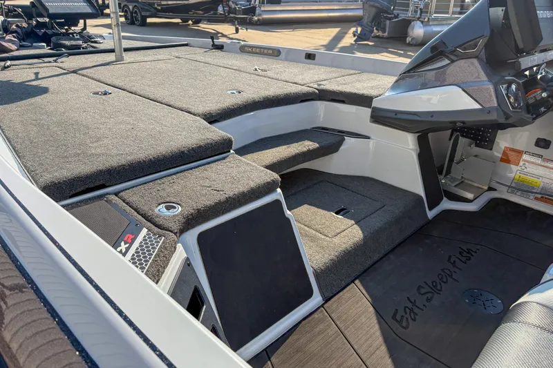 Slide: The Image of 2022 Skeeter FXR20 boat interior with carpeted deck and modern console. - 7