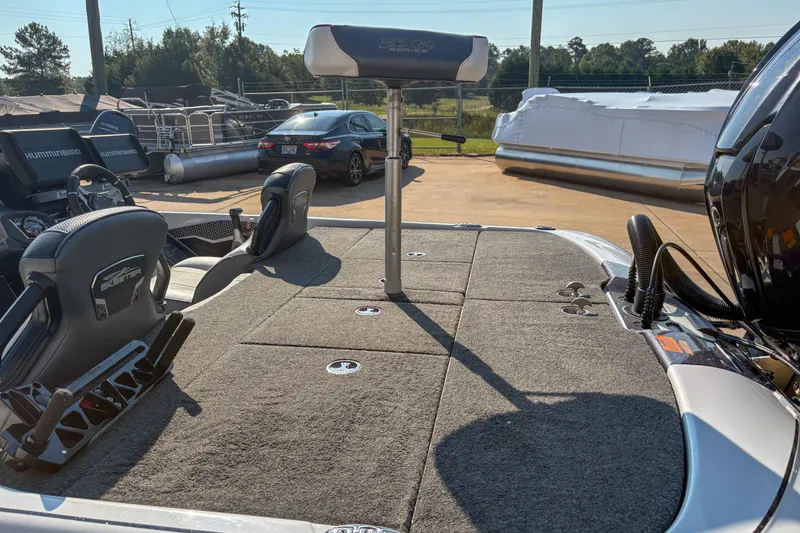 Slide: The Image of 2022 Skeeter FXR20 boat interior with seating and deck, parked outdoors. - 8