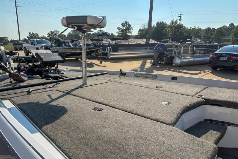 Slide: The Image of 2022 Skeeter FXR20 boat with spacious deck, parked outdoors in a marina. - 9