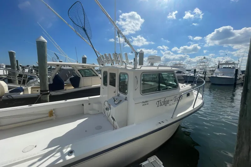 Slide: The Image of 2007 Parker 2820 XLD Sport Cabin boat docked under a sunny sky. - 0