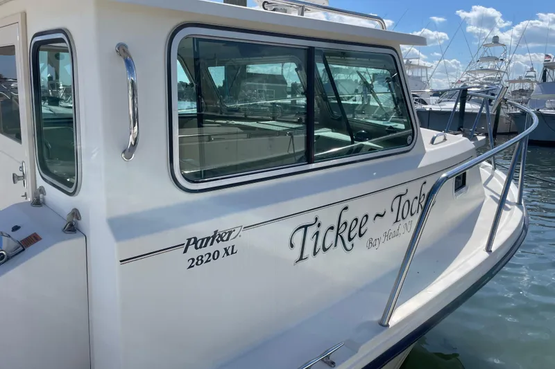 Slide: The Image of 2007 Parker 2820 XLD Sport Cabin boat docked, featuring "Tickee Tock" name on the side. - 1