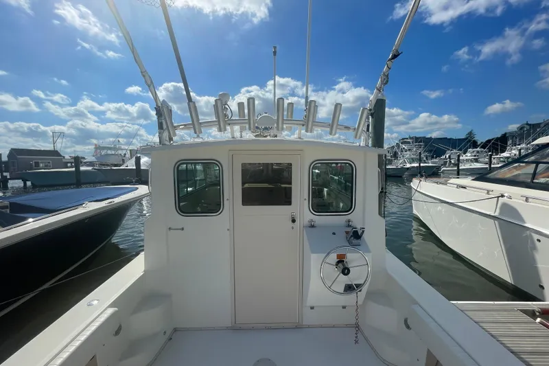 Slide: The Image of 2007 Parker 2820 XLD Sport Cabin boat docked under a clear blue sky. - 10
