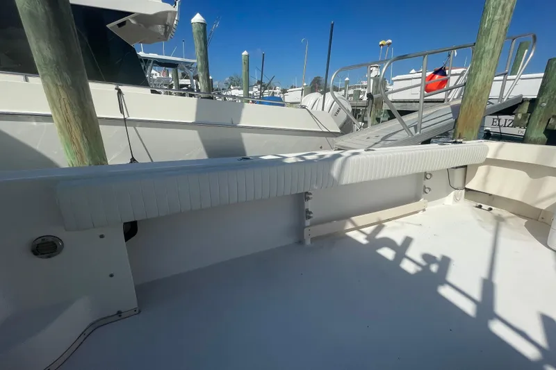Slide: The Image of 2007 Parker 2820 XLD Sport Cabin boat docked, featuring a spacious deck and seating area. - 102