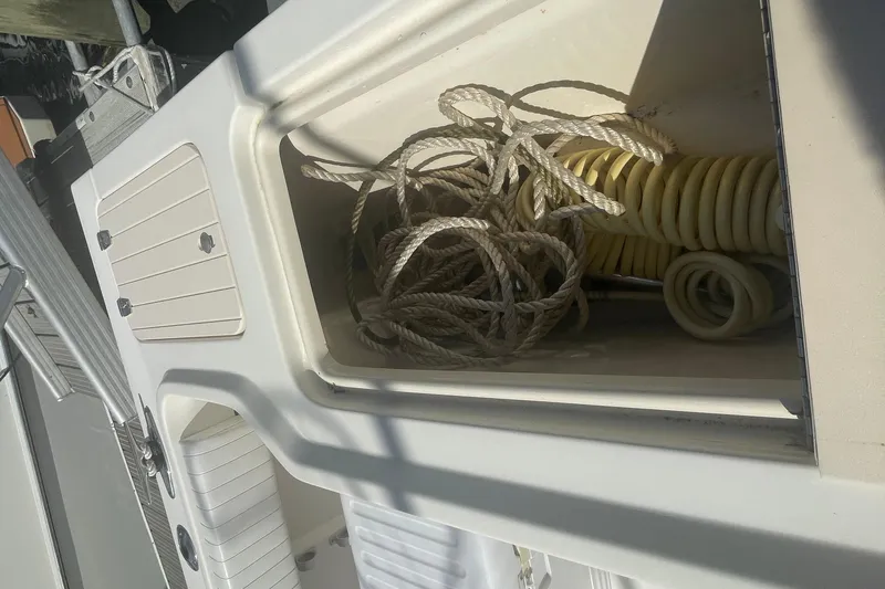 Slide: The Image of Storage compartment on 2007 Parker 2820 XLD Sport Cabin boat with ropes and hose. - 21