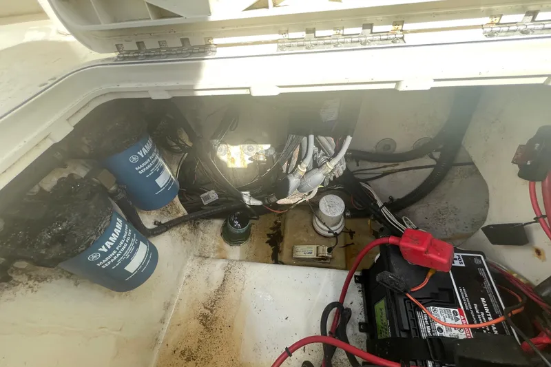 Slide: The Image of 2007 Parker 2820 XLD Sport Cabin engine compartment with Yamaha filters and marine battery. - 27