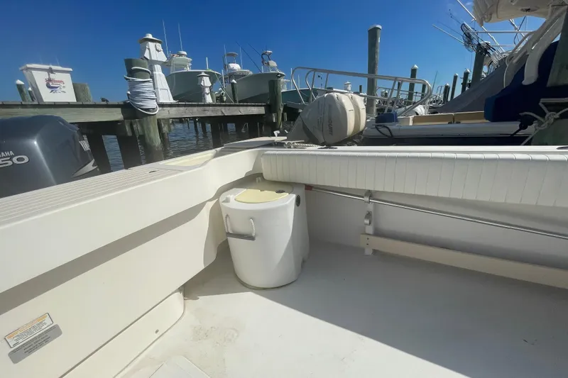 Slide: The Image of 2007 Parker 2820 XLD Sport Cabin boat docked, featuring a clean deck and seating area. - 29