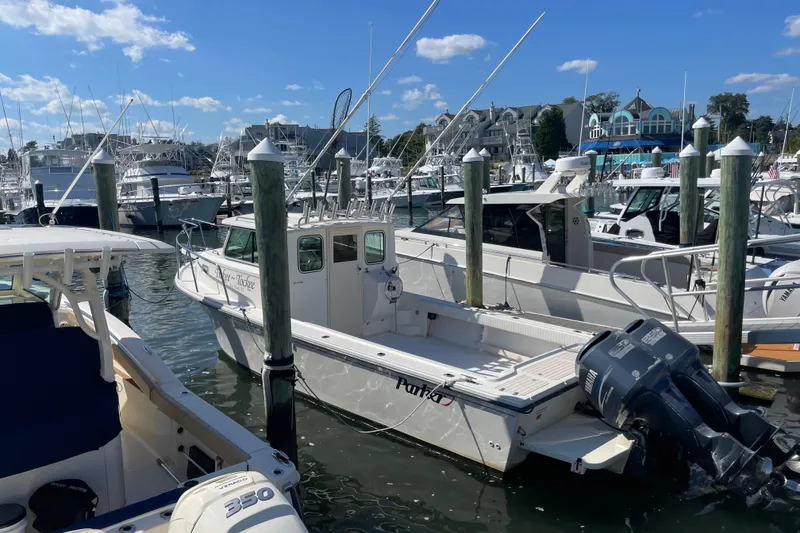 Slide: The Image of 2007 Parker 2820 XLD Sport Cabin boat docked at marina, surrounded by other vessels. - 3