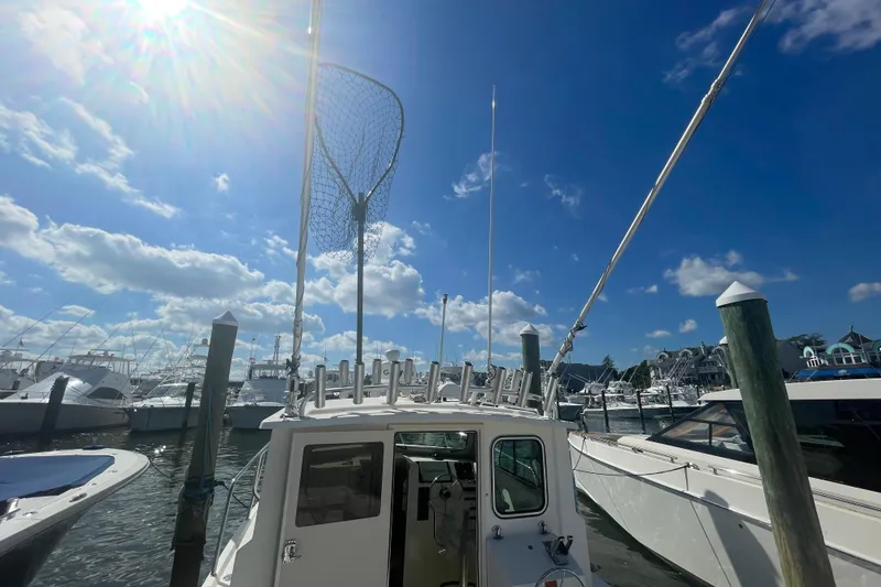Slide: The Image of 2007 Parker 2820 XLD Sport Cabin boat docked under sunny blue sky. - 35
