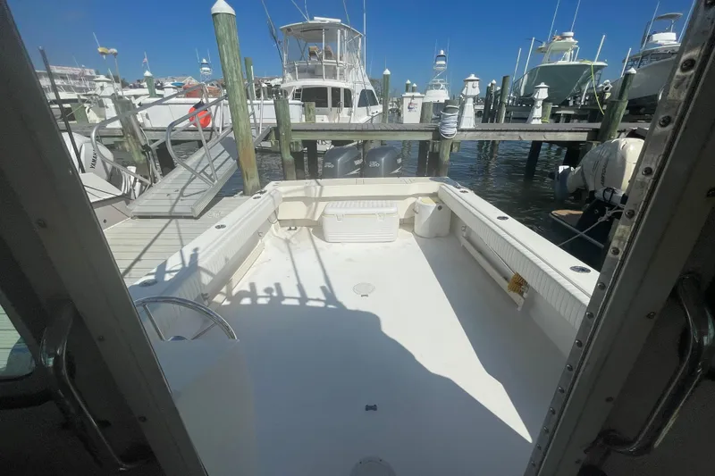 Slide: The Image of 2007 Parker 2820 XLD Sport Cabin at marina, showcasing spacious deck and docked boats. - 36