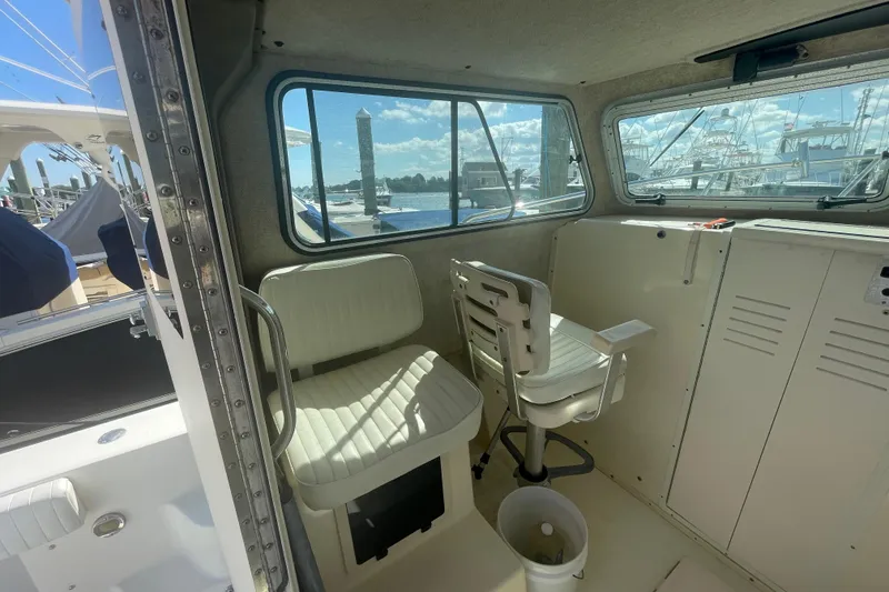 Slide: The Image of Interior of 2007 Parker 2820 XLD Sport Cabin with seating and windows overlooking marina. - 39