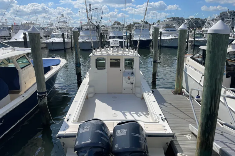 Slide: The Image of 2007 Parker 2820 XLD Sport Cabin boat docked at marina with twin Yamaha engines. - 4
