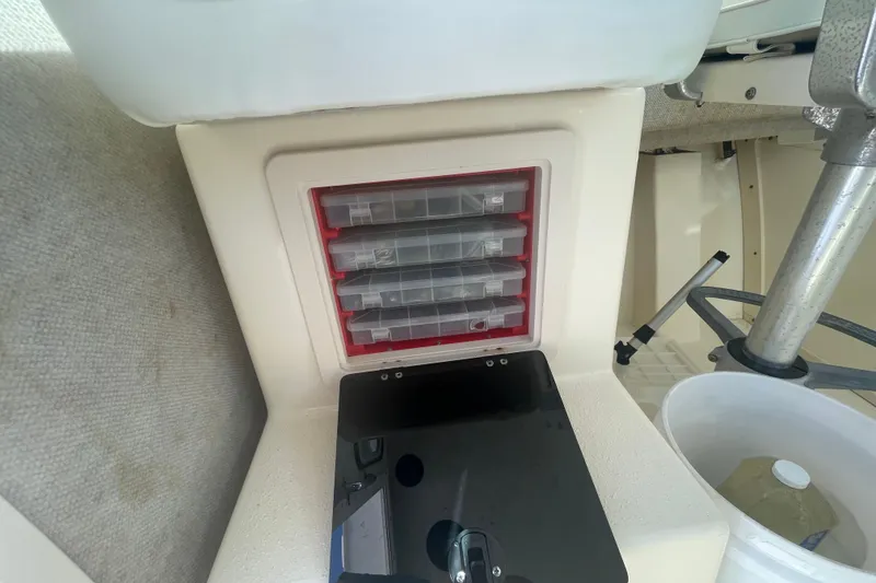Slide: The Image of Storage compartment in 2007 Parker 2820 XLD Sport Cabin boat with tackle boxes. - 41