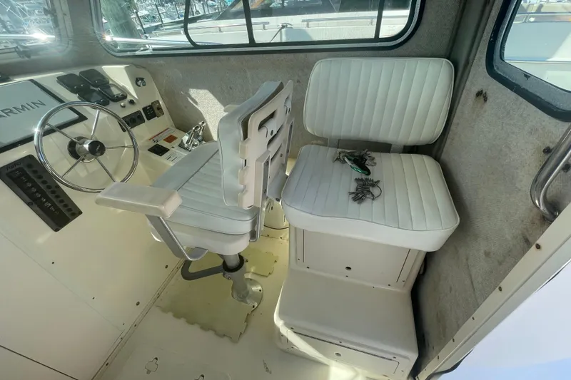 Slide: The Image of Interior of 2007 Parker 2820 XLD Sport Cabin with white seating and steering wheel. - 42