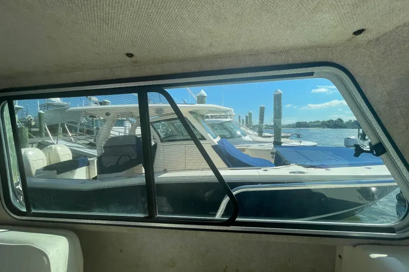 Slide: The Image of 2007 Parker 2820 XLD Sport Cabin boat docked, viewed through cabin window. - 48