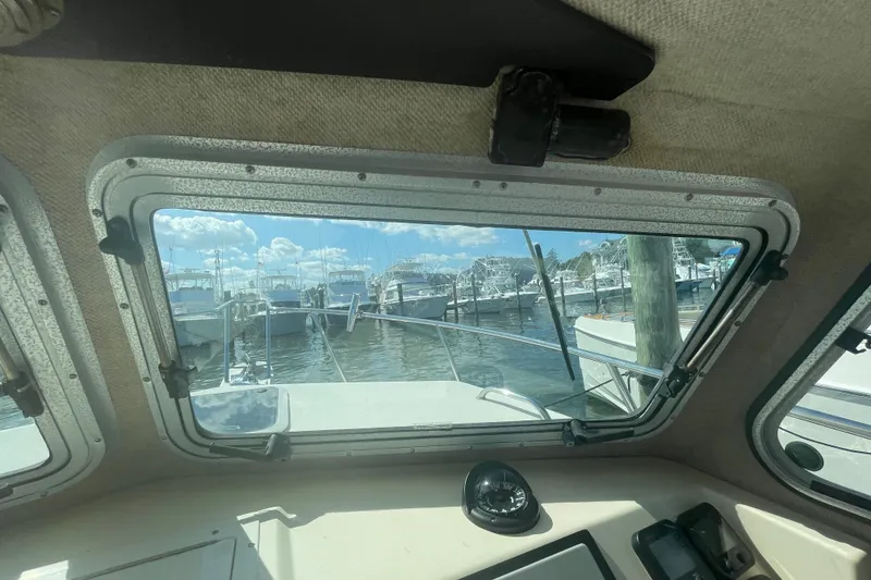 Slide: The Image of Interior view from a 2007 Parker 2820 XLD Sport Cabin, overlooking a marina. - 50
