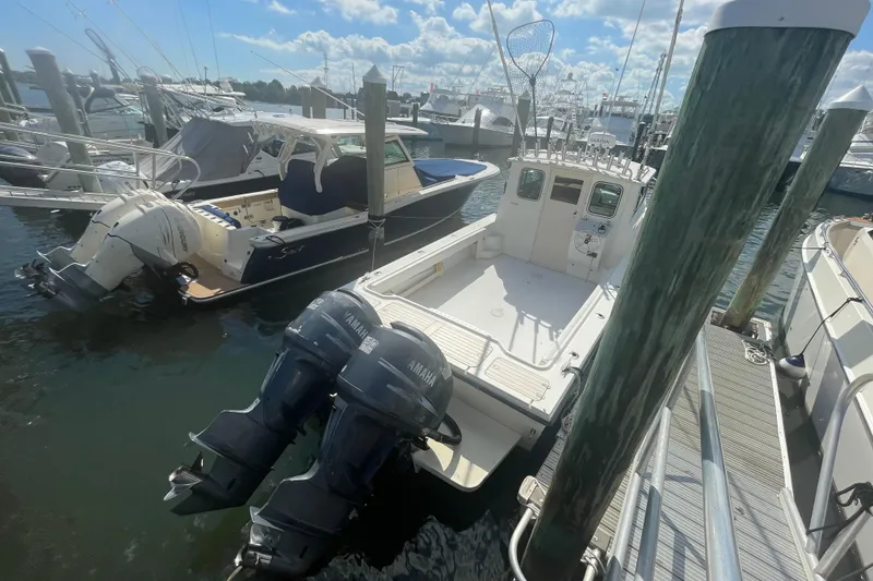 Slide: The Image of 2007 Parker 2820 XLD Sport Cabin boat docked with twin Yamaha engines. - 6
