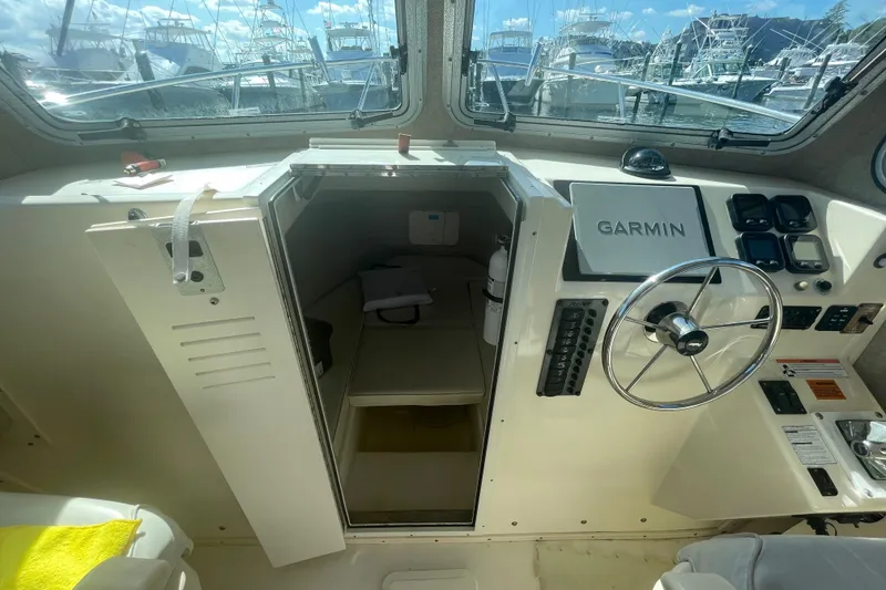 Slide: The Image of 2007 Parker 2820 XLD Sport Cabin interior with Garmin navigation and steering wheel. - 66