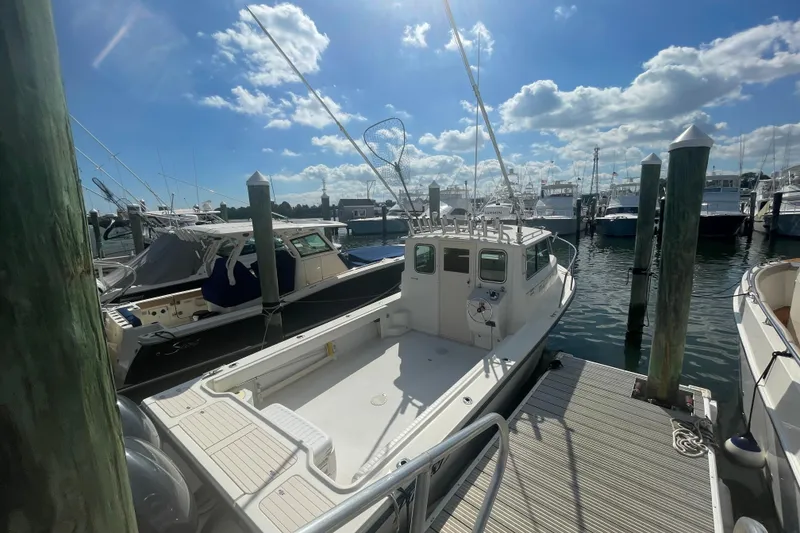 Slide: The Image of 2007 Parker 2820 XLD Sport Cabin boat docked at marina under blue sky. - 7