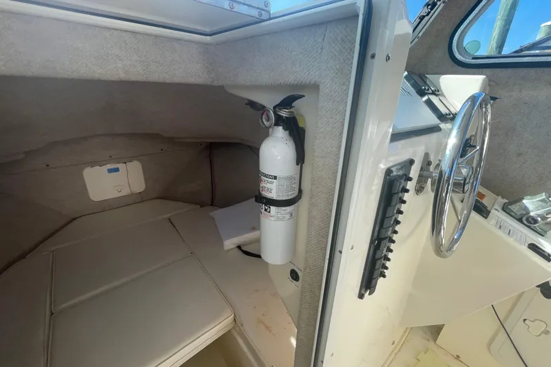 Slide: The Image of 2007 Parker 2820 XLD Sport Cabin interior with steering wheel and fire extinguisher. - 74