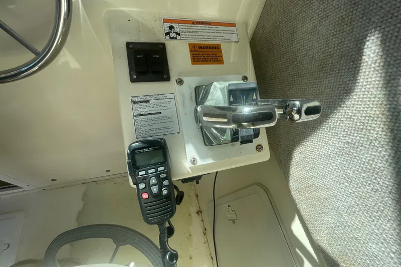 Slide: The Image of Control panel of a 2007 Parker 2820 XLD Sport Cabin boat with steering wheel and radio. - 75