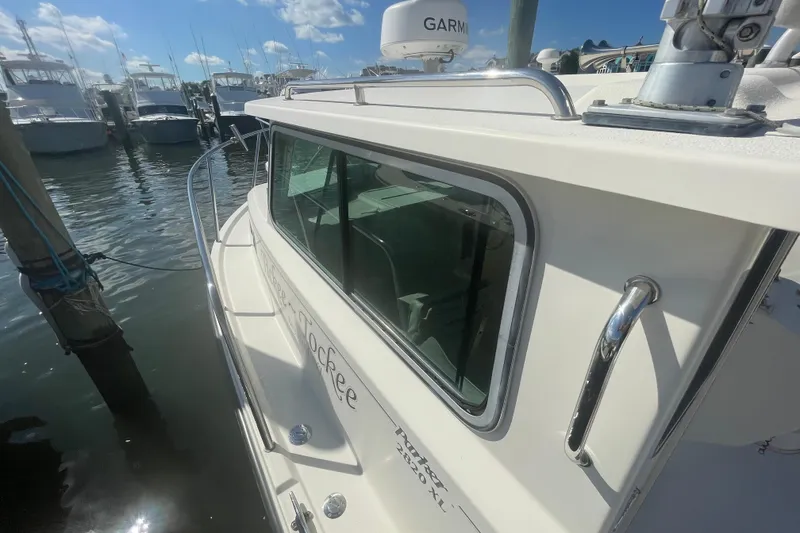 Slide: The Image of 2007 Parker 2820 XLD Sport Cabin boat docked at marina under clear blue sky. - 79