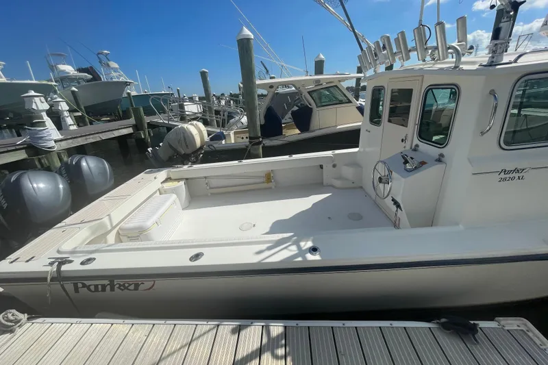 Slide: The Image of 2007 Parker 2820 XLD Sport Cabin boat docked at marina under clear blue sky. - 8