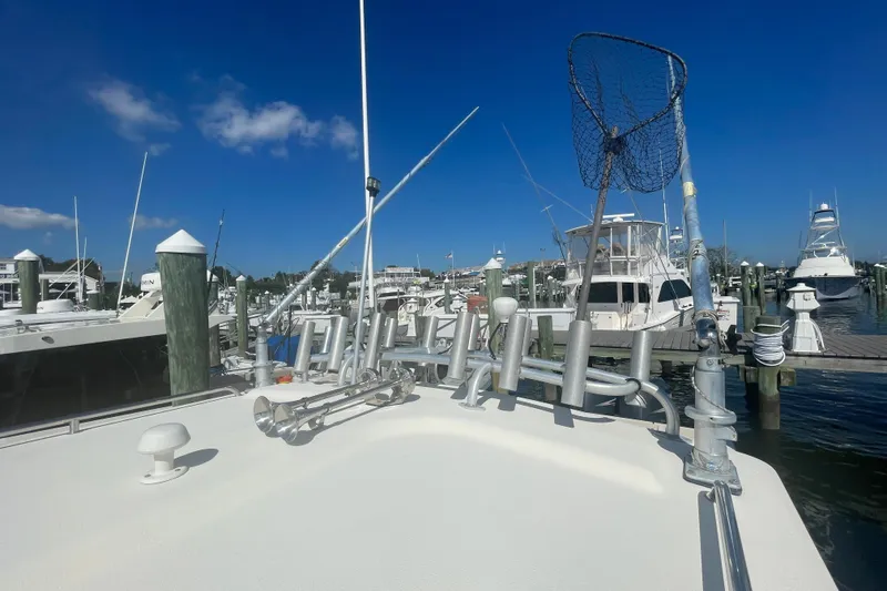 Slide: The Image of 2007 Parker 2820 XLD Sport Cabin at marina, fishing gear visible, clear blue sky. - 82