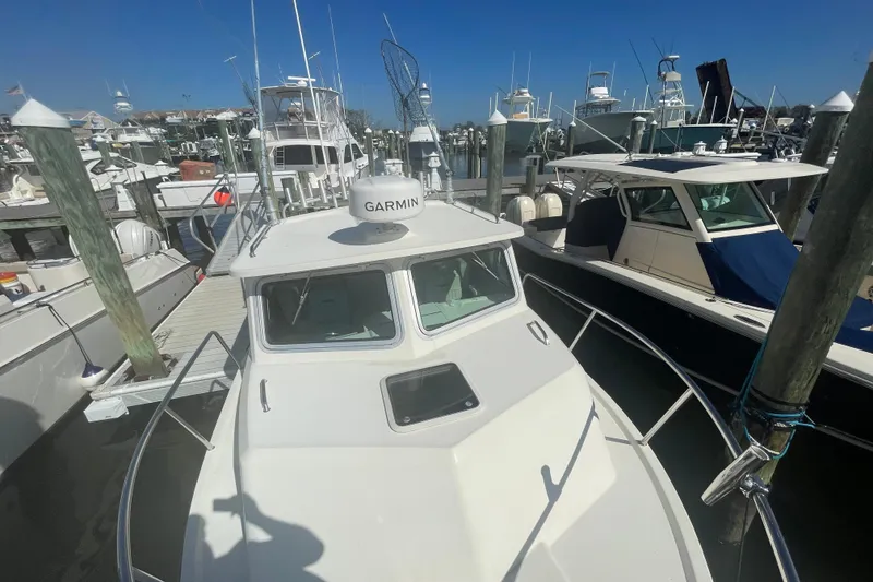 Slide: The Image of 2007 Parker 2820 XLD Sport Cabin boat docked at marina with Garmin equipment. - 90