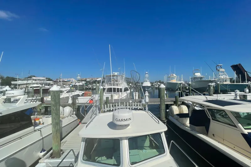 Slide: The Image of Boats docked at a marina, featuring a 2007 Parker 2820 XLD Sport Cabin. - 93