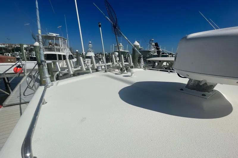 Slide: The Image of 2007 Parker 2820 XLD Sport Cabin boat docked, showcasing deck and equipment under clear blue sky. - 97