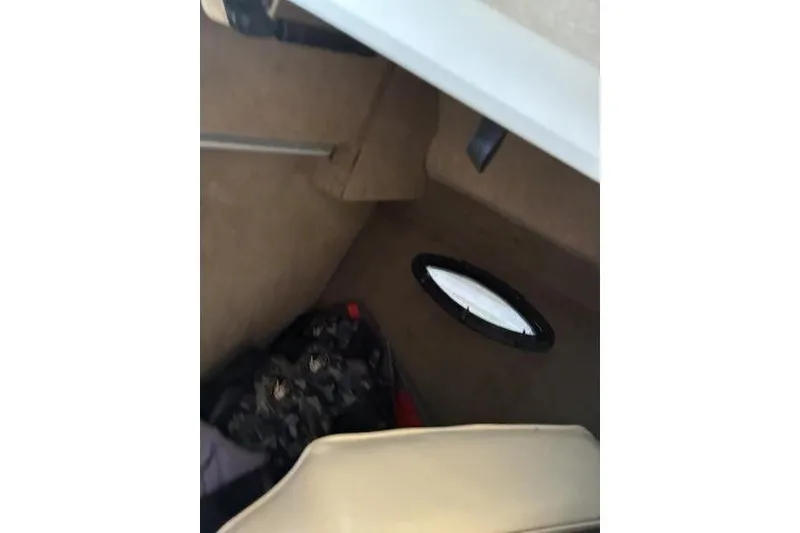 Slide: The Image of Interior cabin of 1999 Ebbtide 2300 boat with small window and storage area. - 13