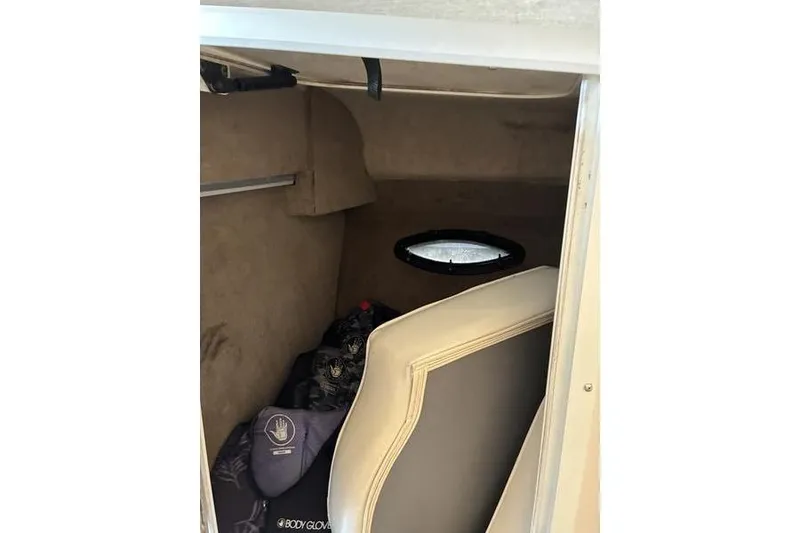 Slide: The Image of Interior cabin of 1999 Ebbtide 2300 boat with seating and porthole. - 14