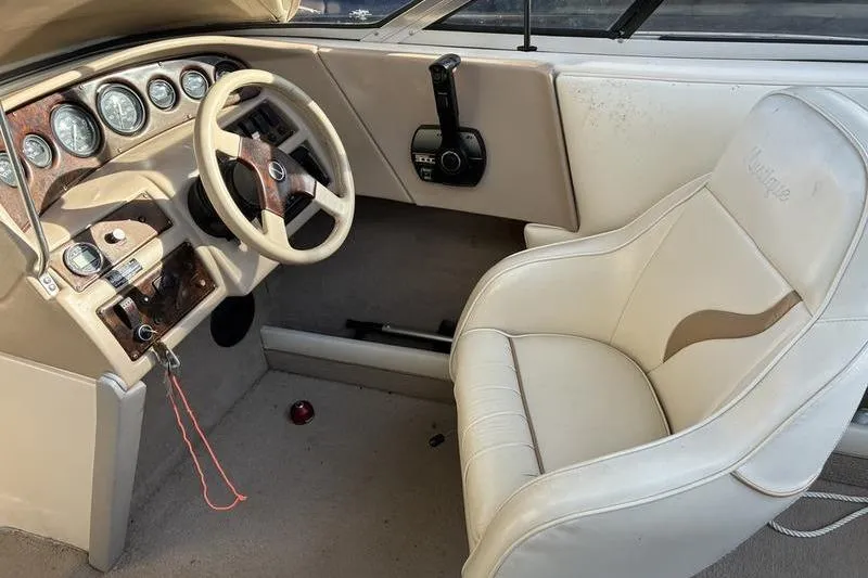 Slide: The Image of 1999 Ebbtide 2300 boat interior with steering wheel and gauges. - 31