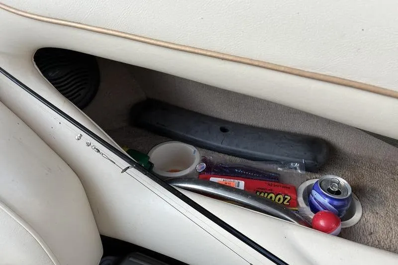 Slide: The Image of Interior of 1999 Ebbtide 2300 boat with storage compartment and various items. - 32